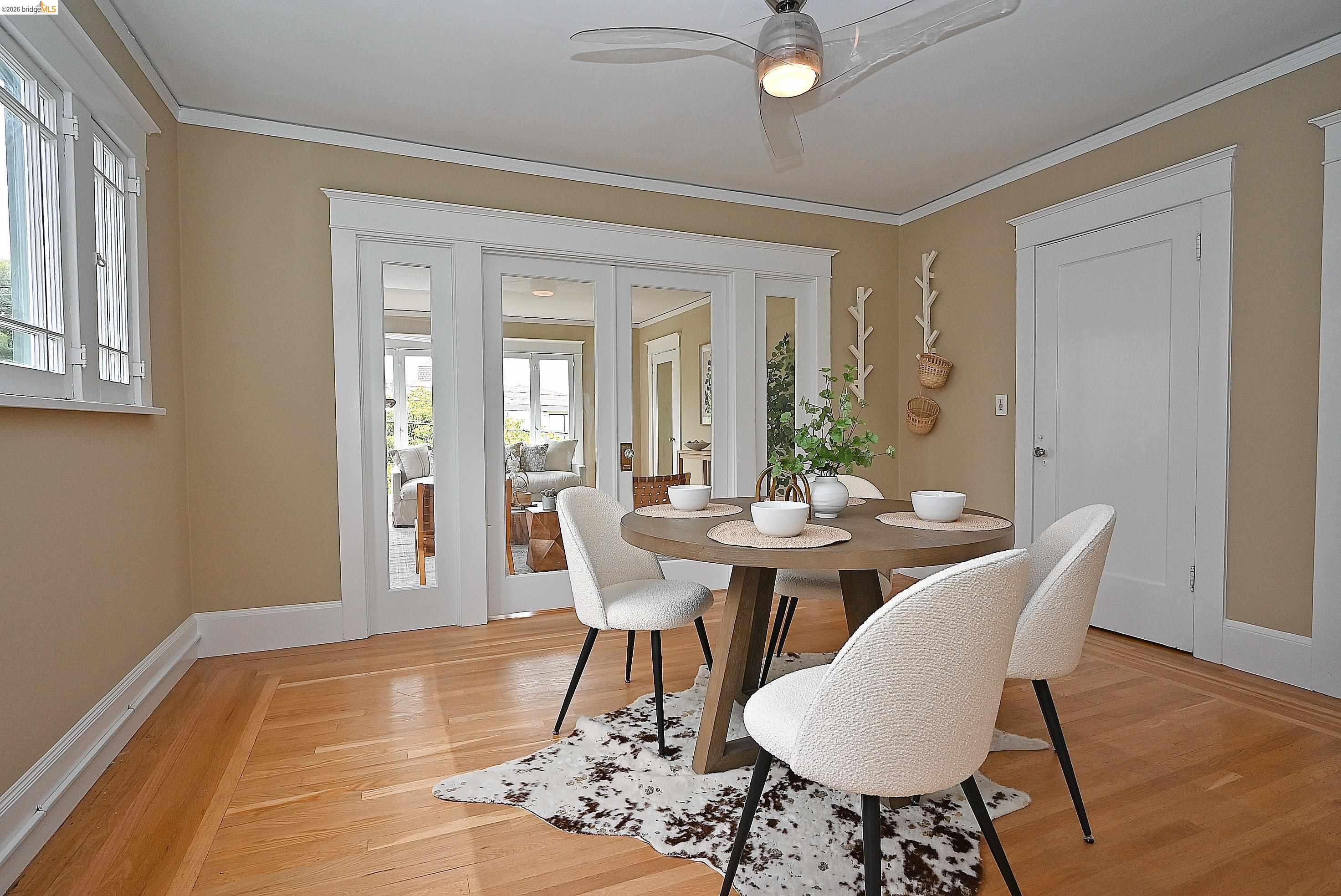 1301 Bonita Avenue, Unit 3 Berkeley, CA 94709 - Photo 23 of 48 Hardwood flooring with border inlay, white trim, and a contemporary ceiling fan
