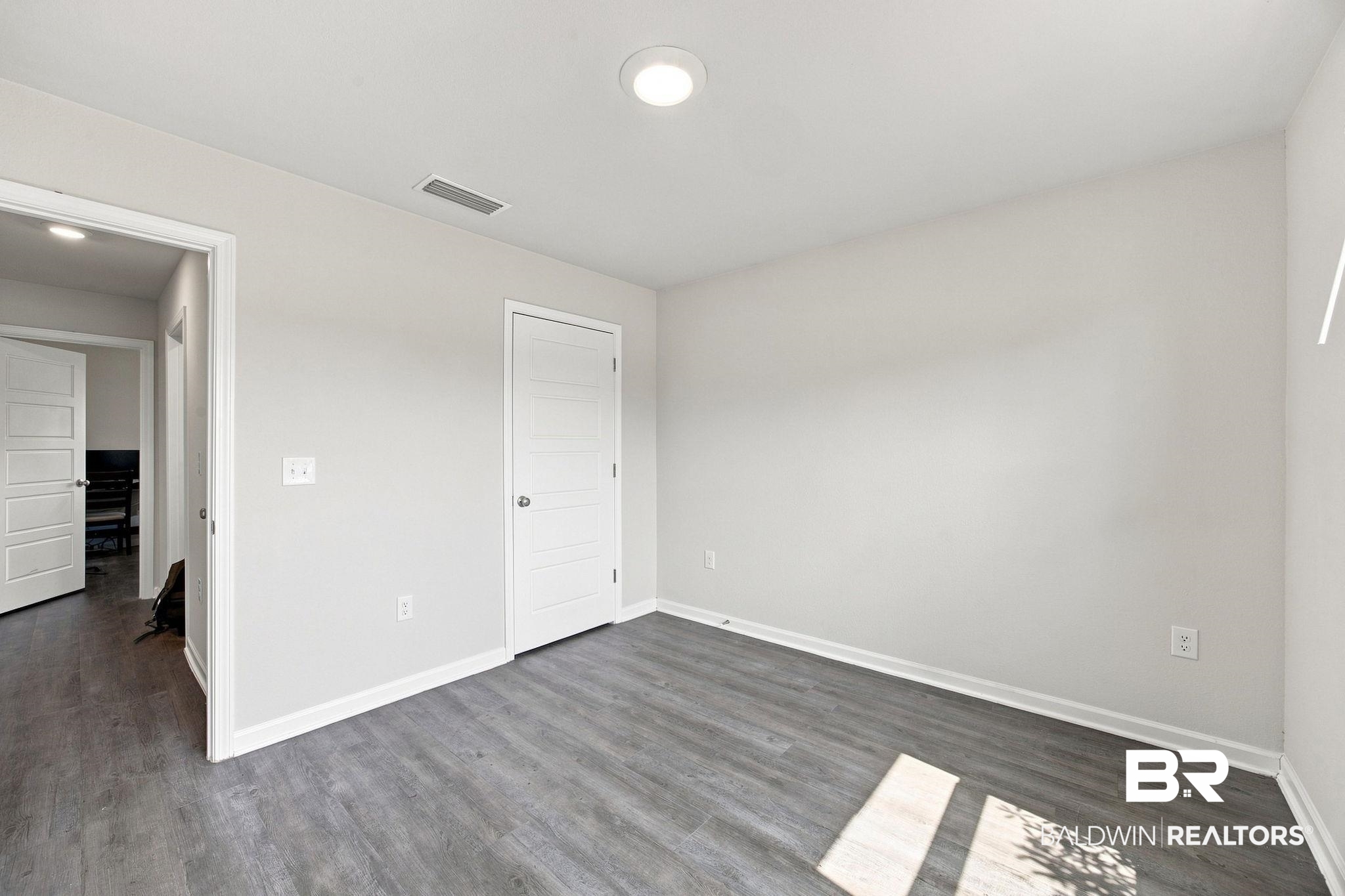 32155 Terranova Loop Lillian, AL 36549 - Photo 20 of 37 Spacious interior room featuring wood-finish flooring, light gray wall paint, and recessed ceiling lighting