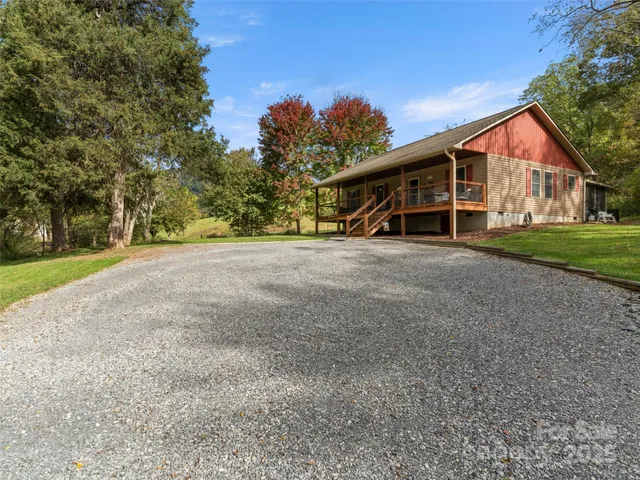 a view of an house with backyard and trees