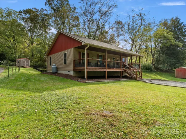a view of house with yard and trampoline