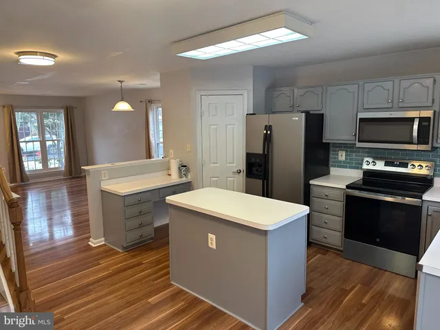 a kitchen with a refrigerator stove and sink