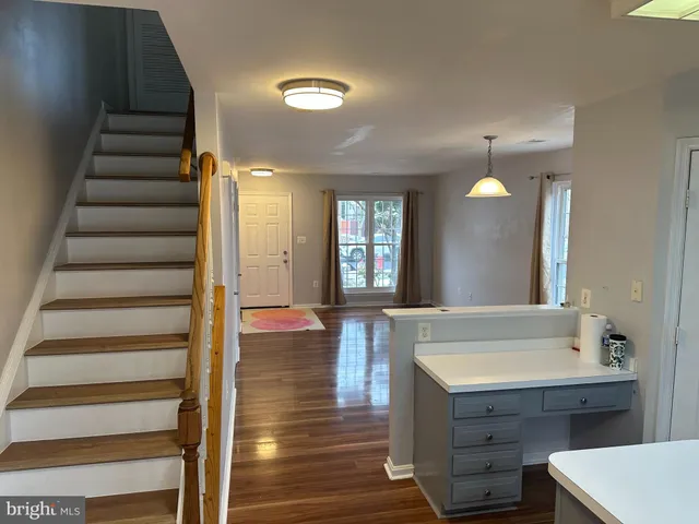 a view of entryway and hall with wooden floor