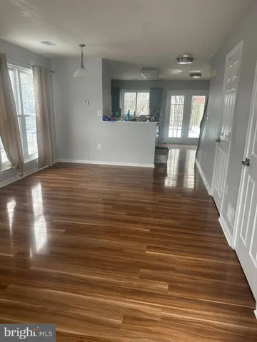 a view of a room with wooden floor