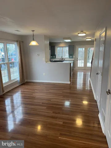 a view of a living room with wooden floor