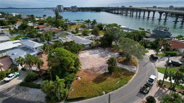 an aerial view of a house with outdoor space and lake view