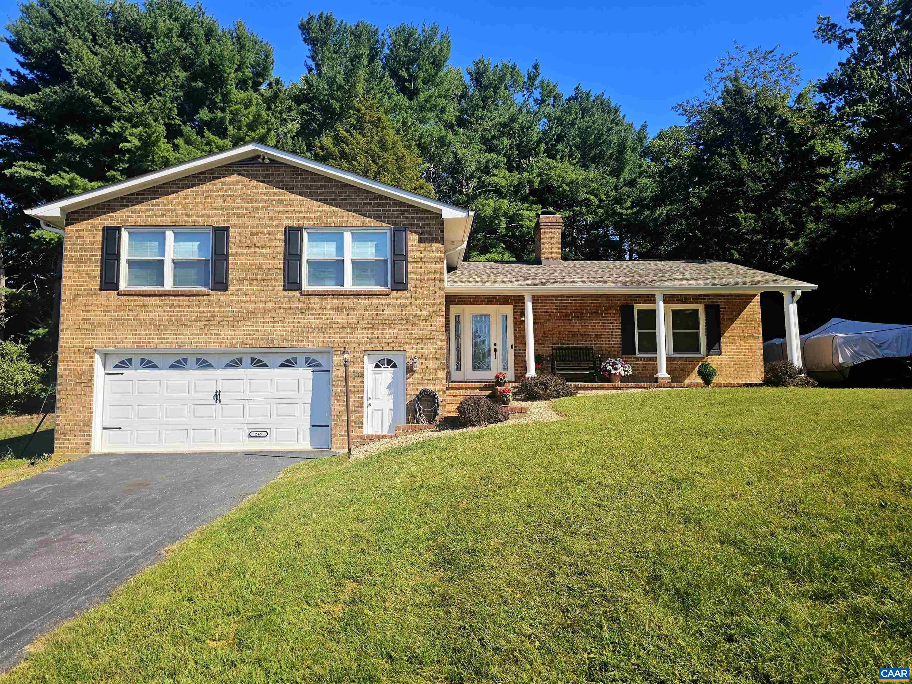 a view of house with yard and sitting area