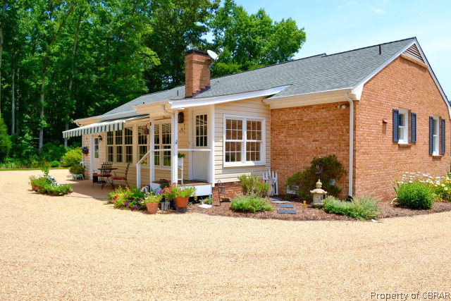 10306 Buckley Hall Road Mathews, VA 23109 - Photo 17 of 22 a front view of a house with a yard and potted plants