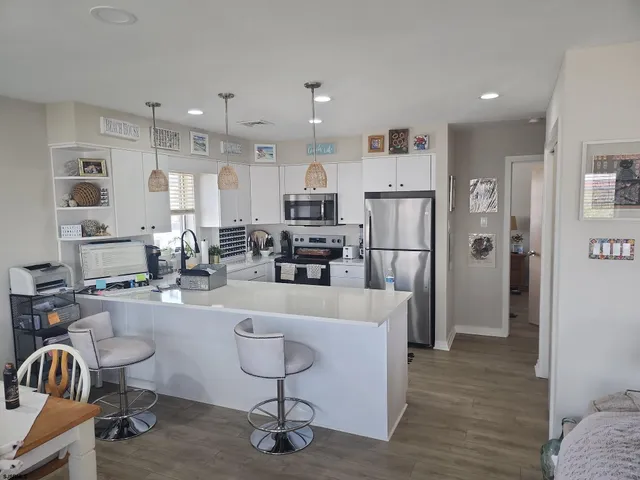 a living room with furniture and kitchen view