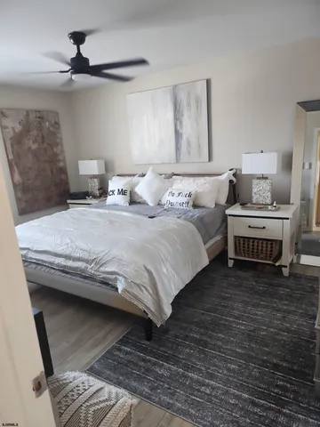 a bedroom with a bed and a ceiling fan