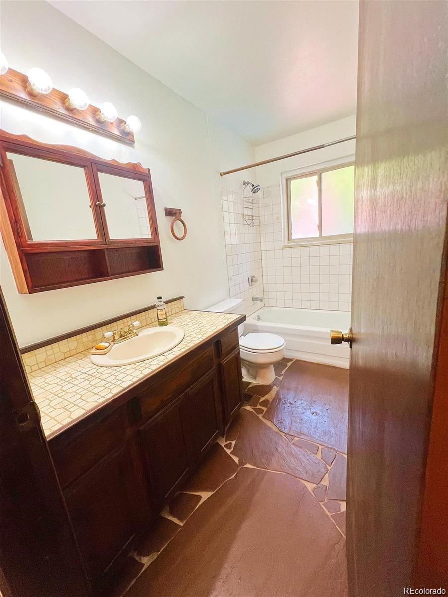 19424 Silver Ranch Road Conifer, CO 80433 - Photo 16 of 17 a bathroom with a bathtub a sink and a mirror