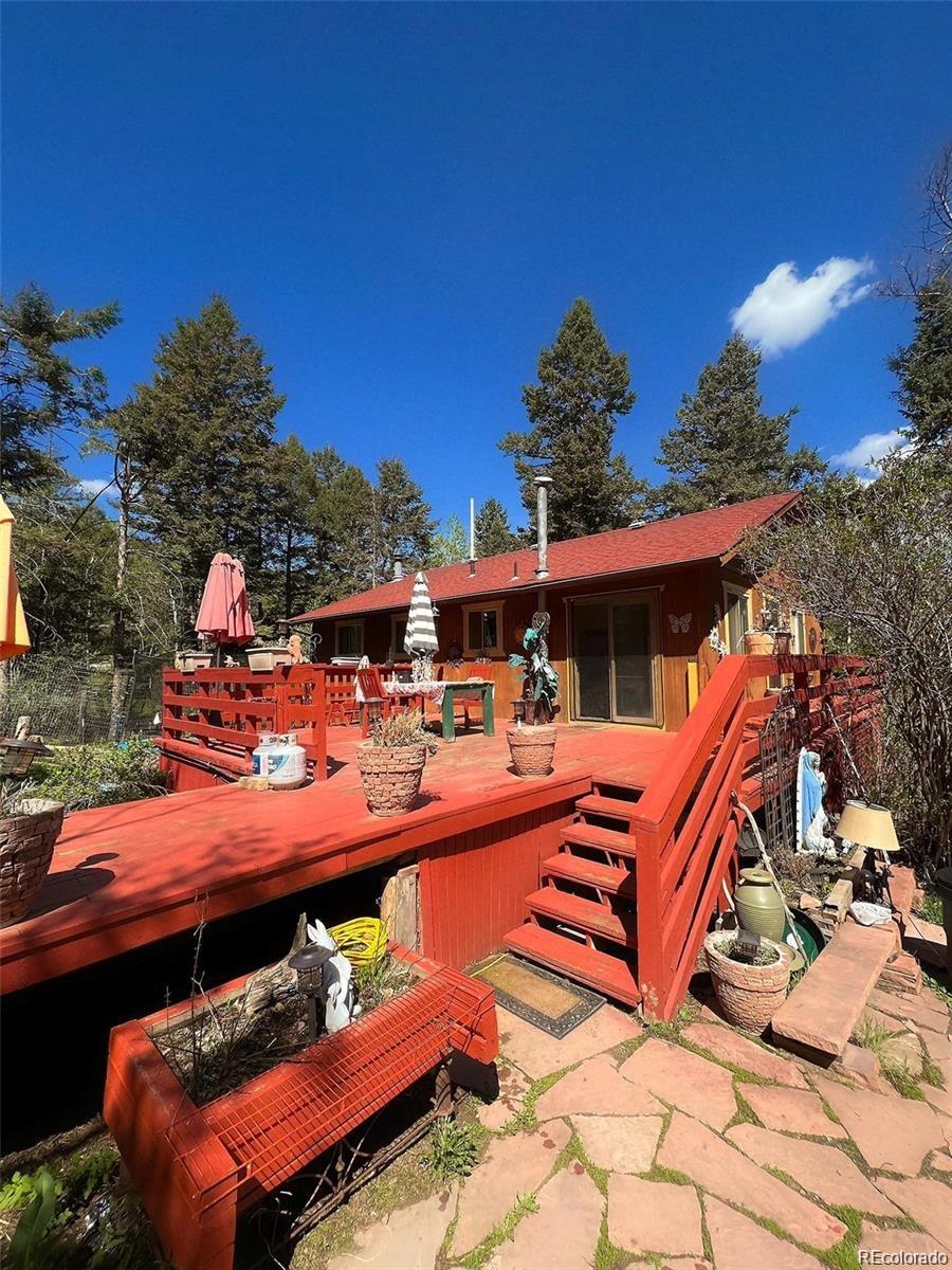 19424 Silver Ranch Road Conifer, CO 80433 - Photo 2 of 17 an outdoor sitting area with a couch