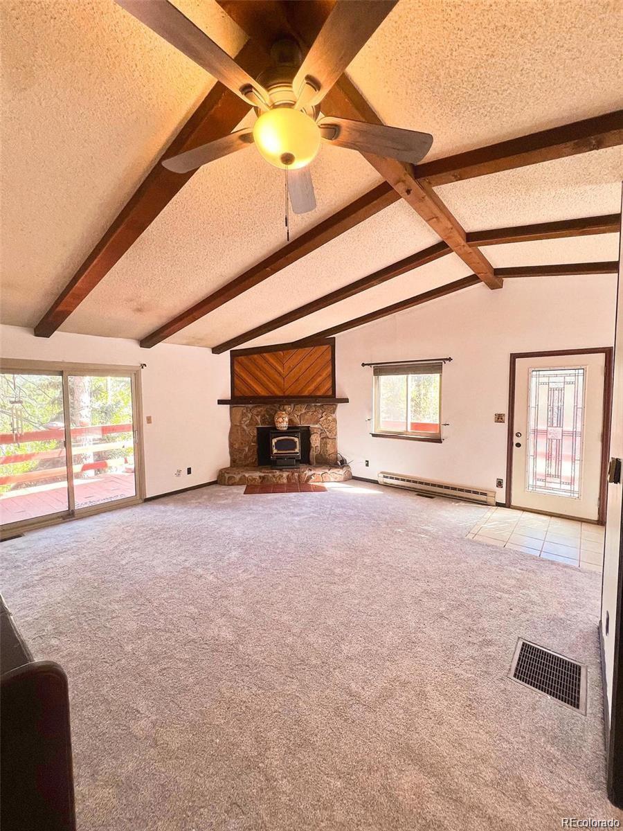 19424 Silver Ranch Road Conifer, CO 80433 - Photo 5 of 17 a view of a livingroom with an empty space and a window