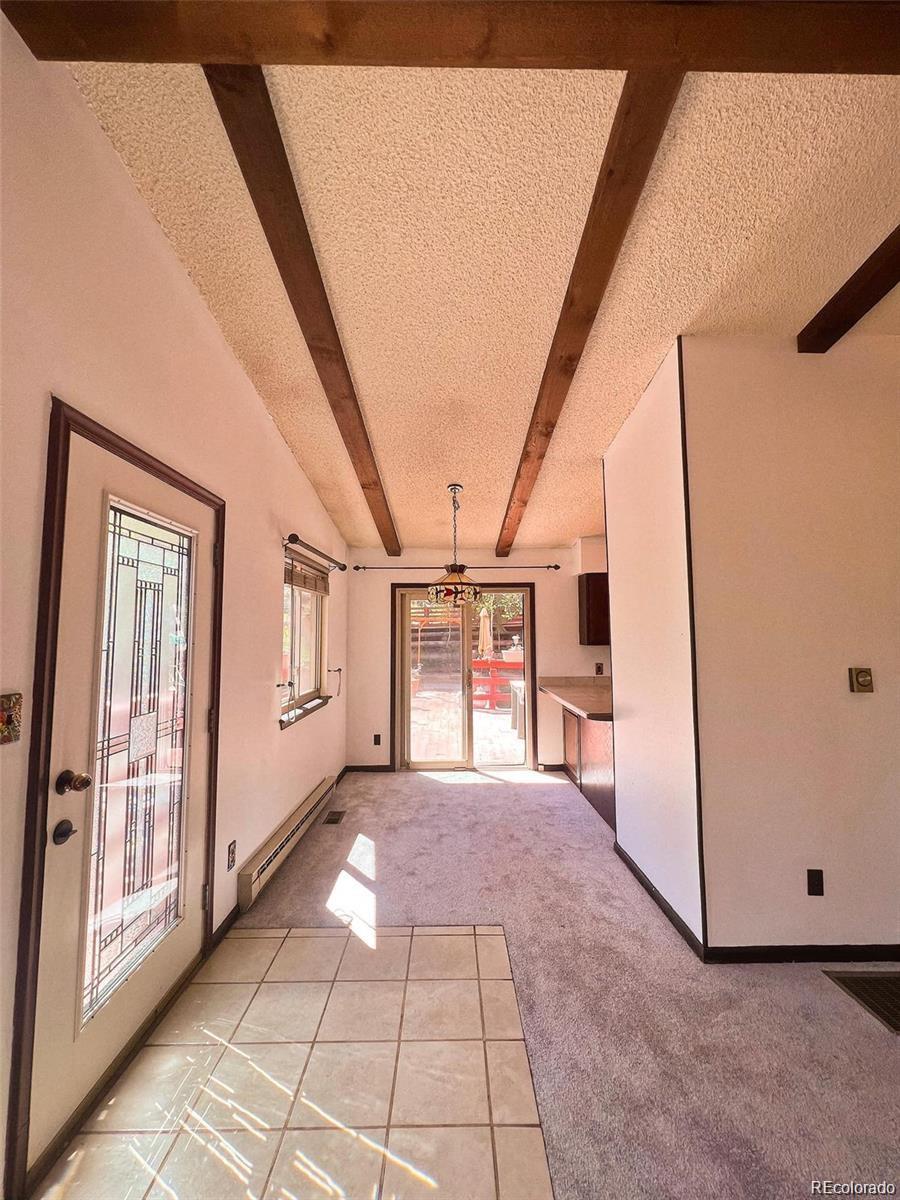 19424 Silver Ranch Road Conifer, CO 80433 - Photo 6 of 17 a view of a hallway with windows