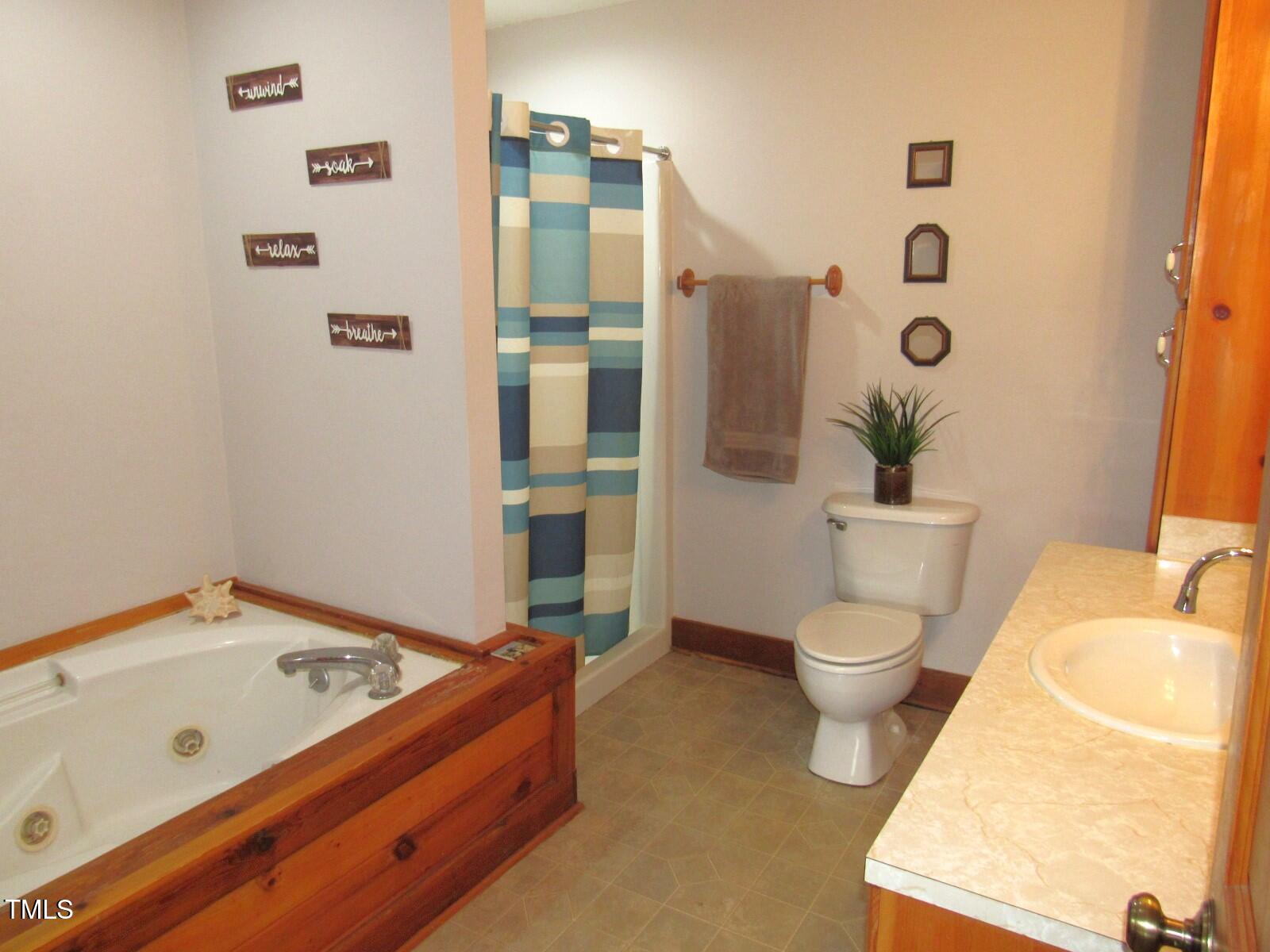 1159 Flemingtown Road Henderson, NC 27537 - Photo 13 of 51 a bathroom with a tub sink and toilet