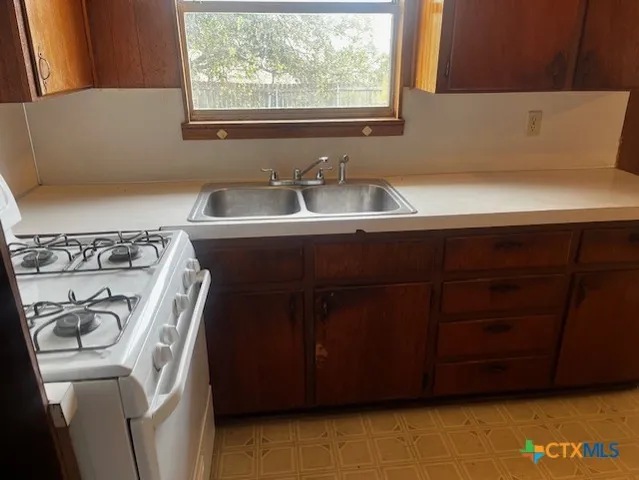 a utility room with a sink washer and dryer