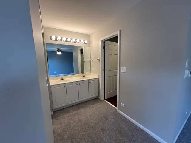 a bathroom with a double vanity sink and mirror