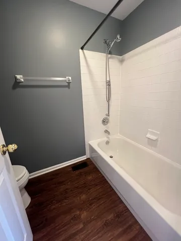 a bathroom with a bathtub a toilet and a shower