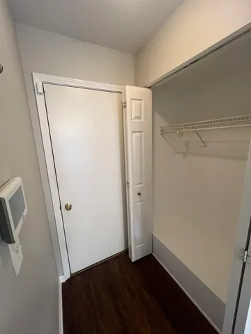 a view of room with window and hardwood floor