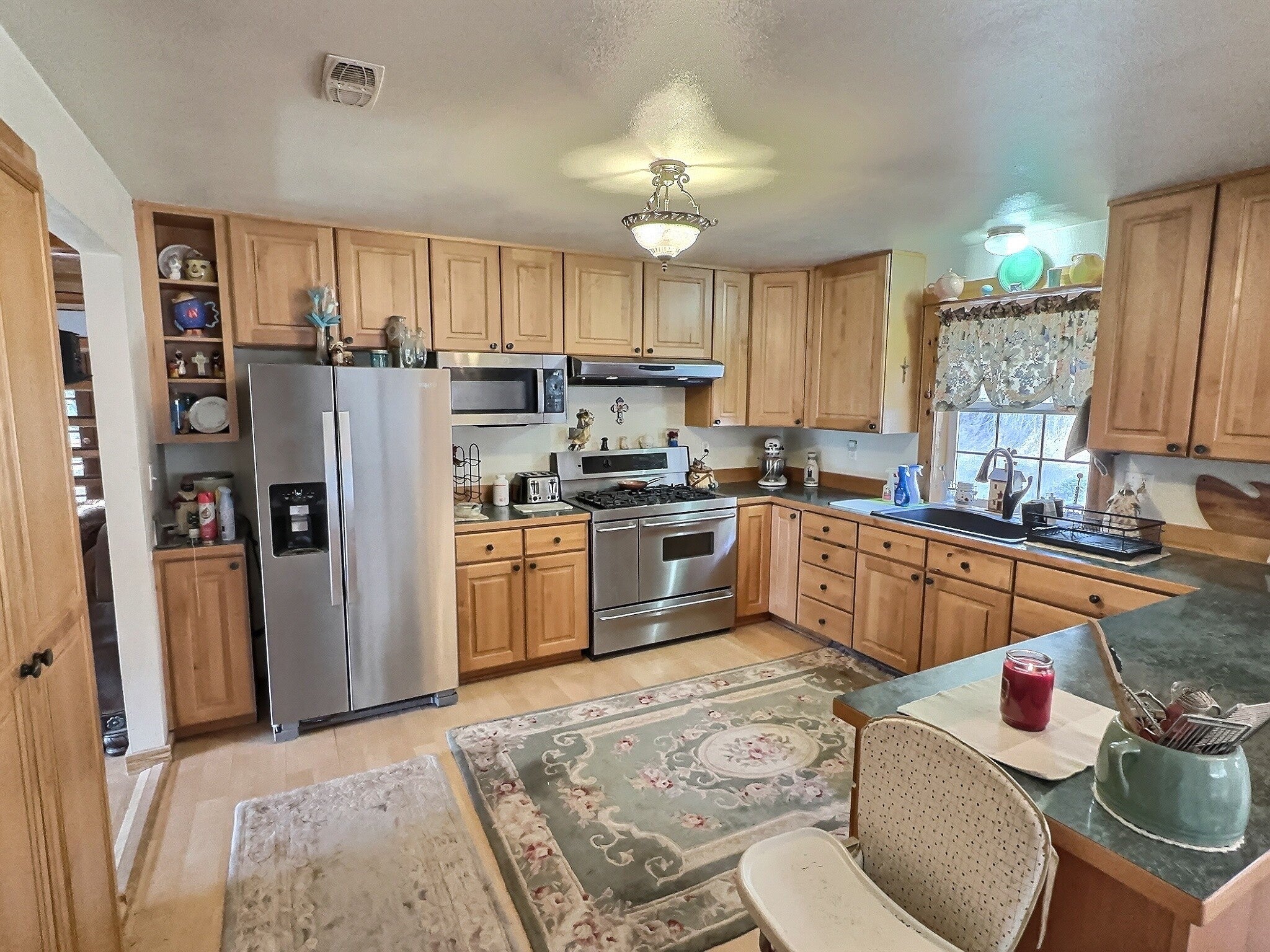 152 Buffalo Bill Road Plains, MT 59859 - Photo 13 of 71 Kitchen featuring sink, light brown cabinets, stainless steel appliances, and light wood-type flooring