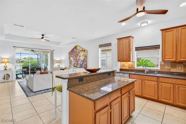 a kitchen with a stove a sink dishwasher and a refrigerator