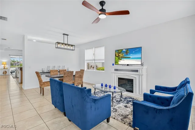 a living room with fireplace furniture and a fireplace