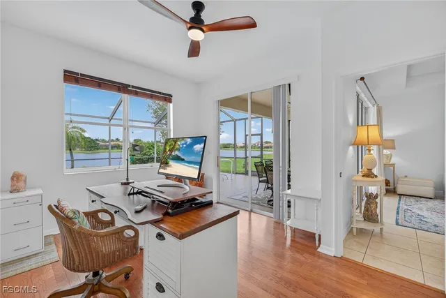 a view of a workspace with furniture and a window