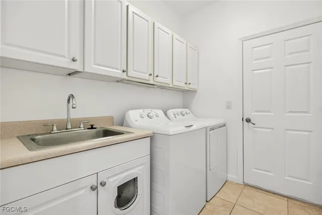 a utility room with sink dryer and washer