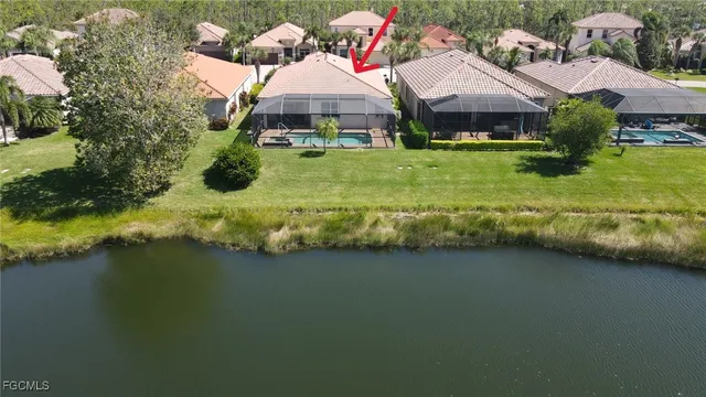 a aerial view of a house with swimming pool garden and lake view