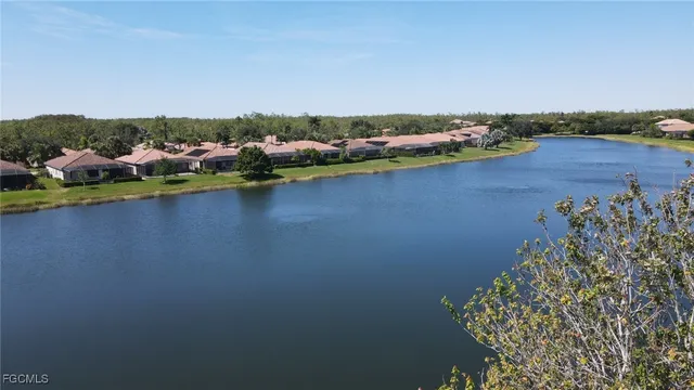 an aerial view of a houses with ocean view