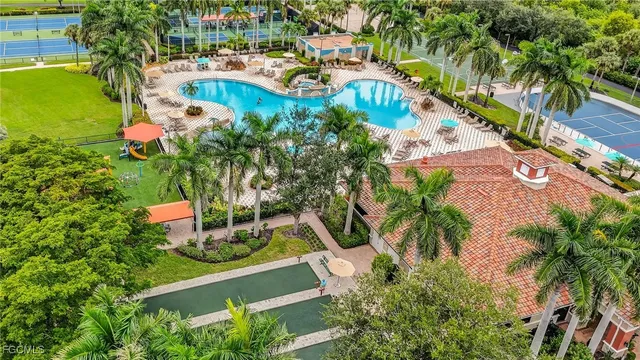 an aerial view of residential houses with outdoor space and trees all around