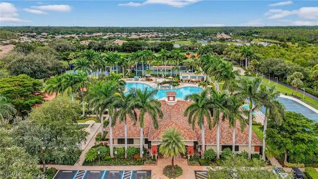 an aerial view of residential houses with outdoor space and trees