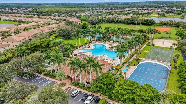 an aerial view of residential houses with outdoor space and trees