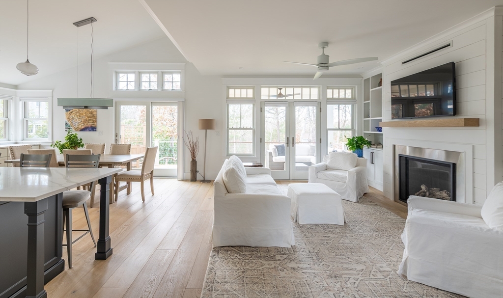 75 Streeter Hill Road Falmouth, MA 02556 - Photo 11 of 32 a living room with furniture a flat screen tv and a fireplace