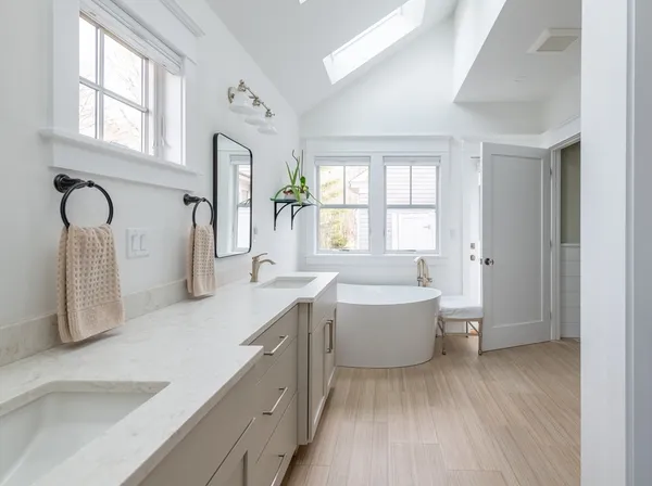 a spacious bathroom with a bathtub sink and mirror
