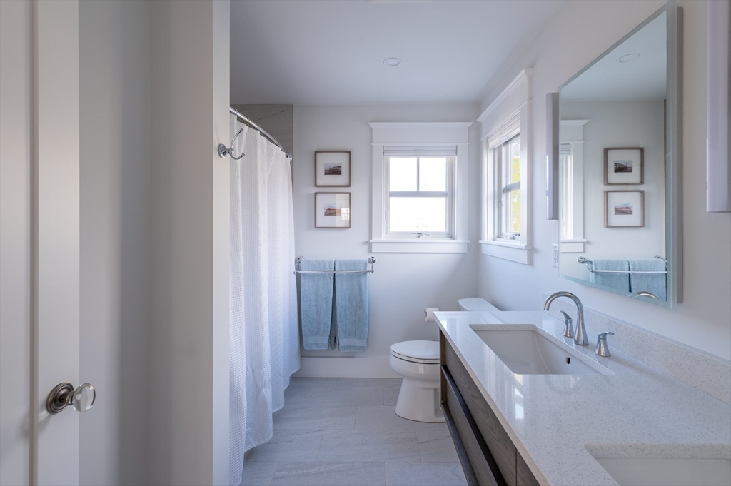 75 Streeter Hill Road Falmouth, MA 02556 - Photo 27 of 32 a bathroom with a bathtub sink mirror and toilet