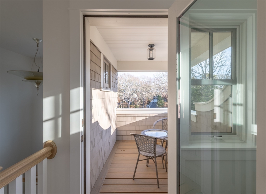 75 Streeter Hill Road Falmouth, MA 02556 - Photo 28 of 32 a view of a balcony with furniture and wooden floor