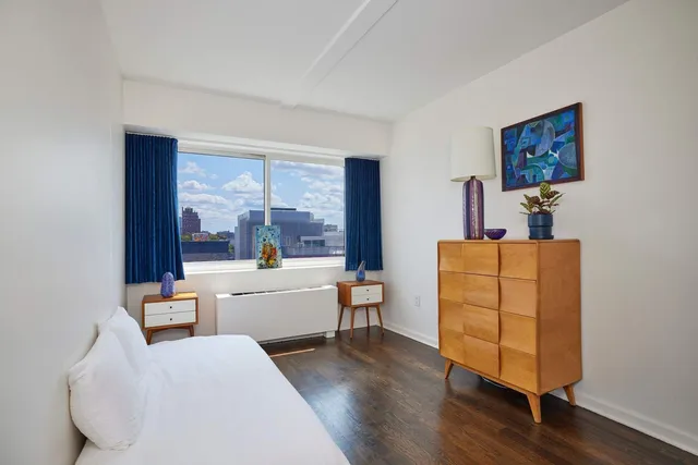 a bedroom with furniture and a wooden floor