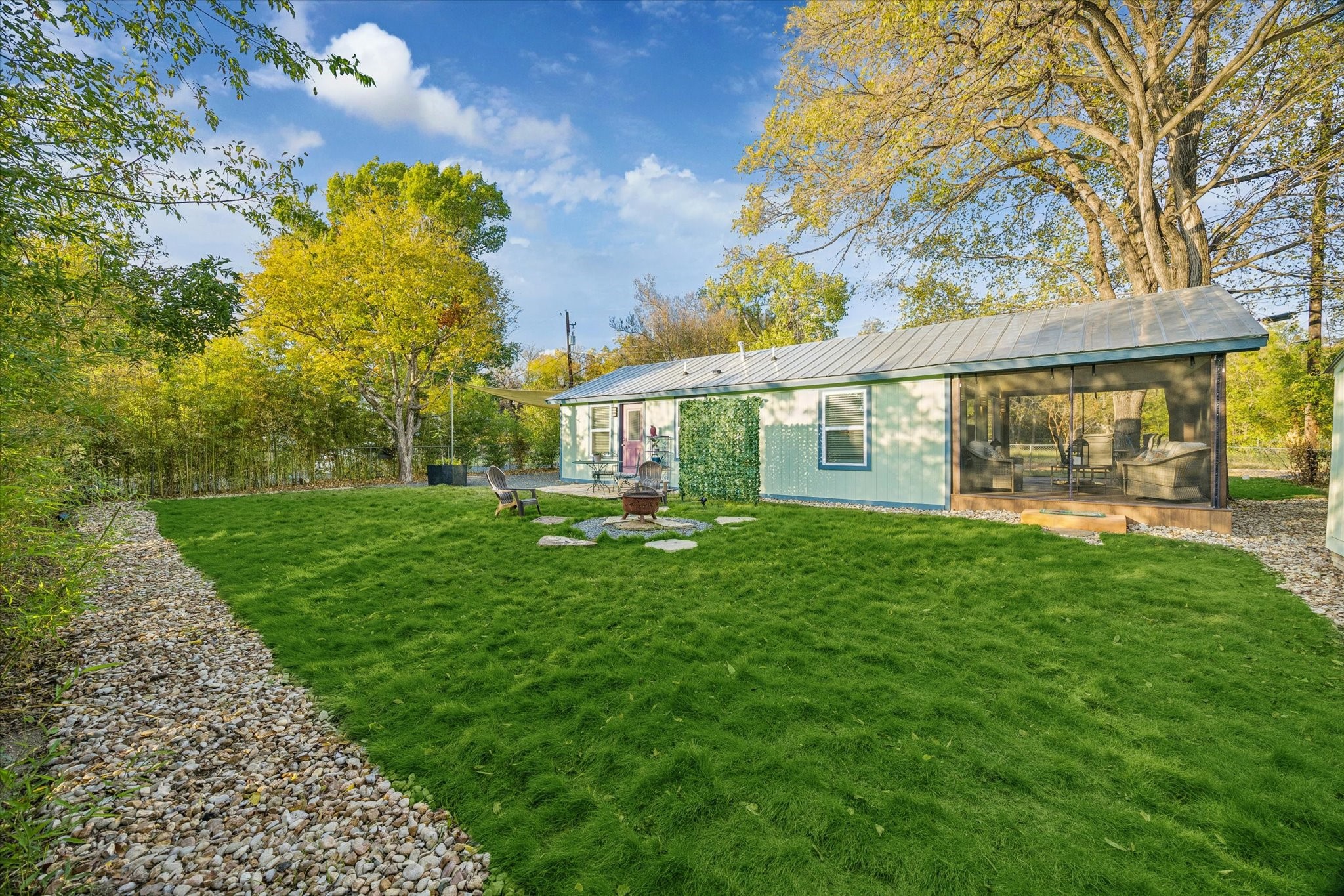 4901 Prock Lane Austin, TX 78721 - Photo 28 of 41 a view of a house with a big yard potted plants and large tree