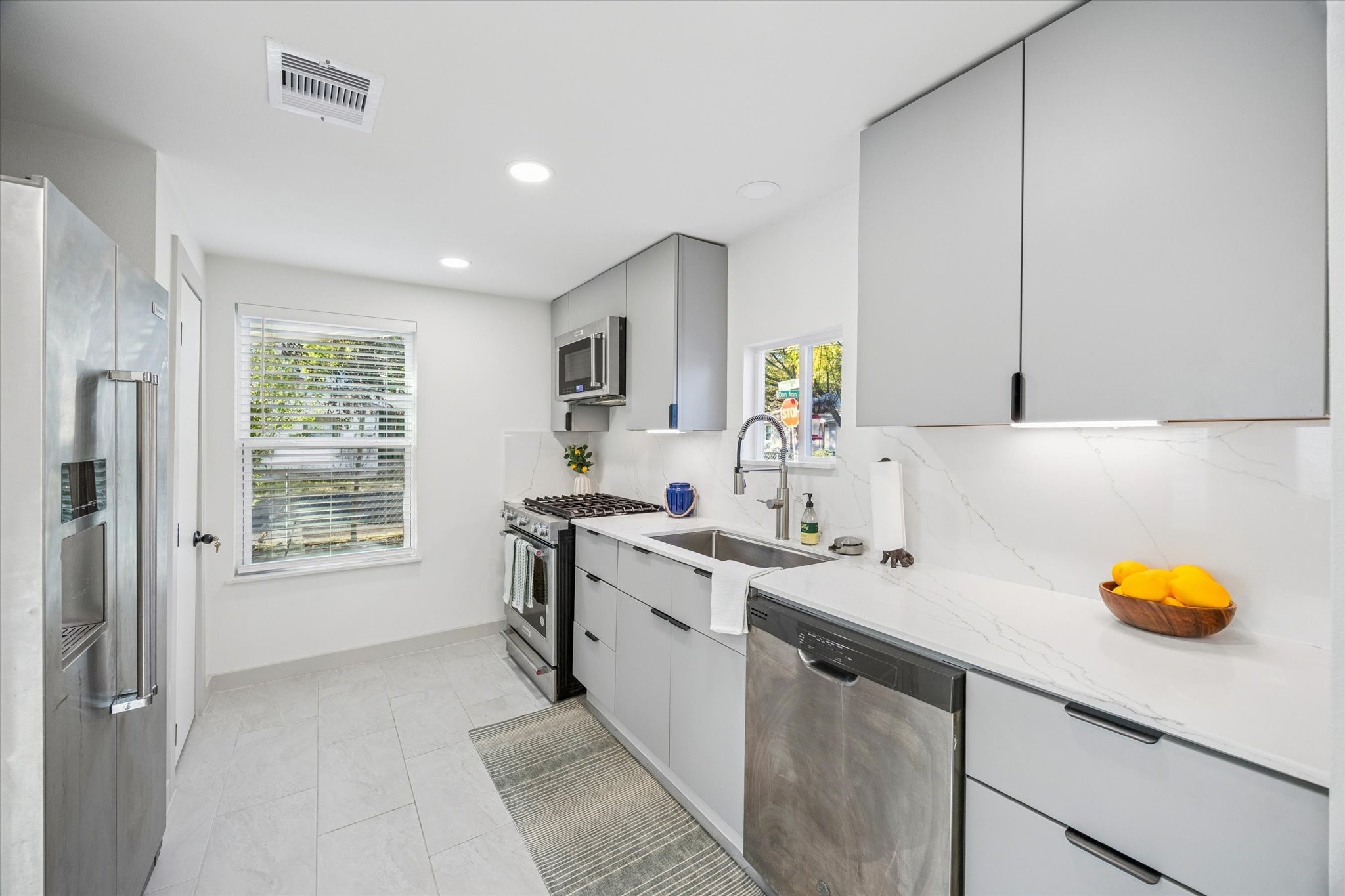 4901 Prock Lane Austin, TX 78721 - Photo 9 of 41 a kitchen with a sink cabinets and window