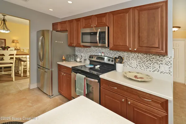 a kitchen with stainless steel appliances granite countertop a refrigerator stove and sink