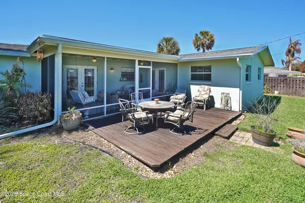 a view of a house with backyard sitting area and garden