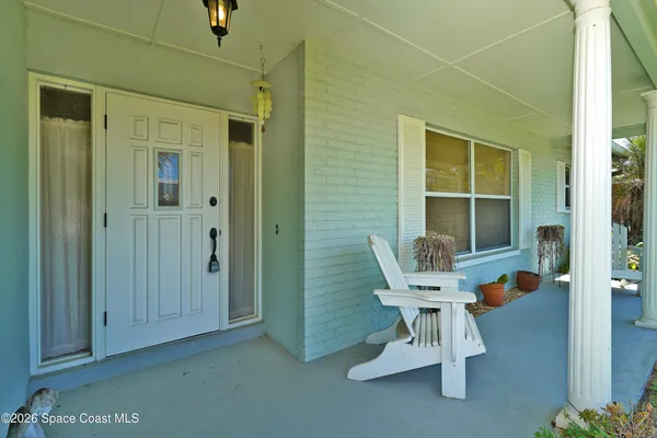 a balcony with table and chairs