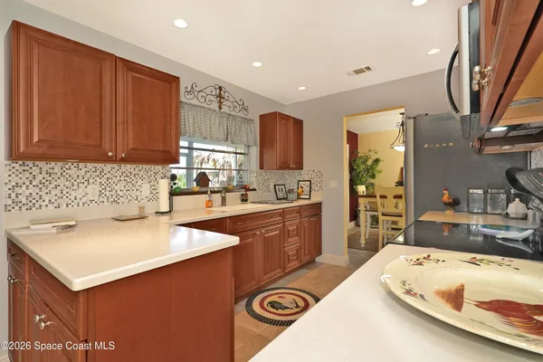 a kitchen with a sink a stove and cabinets