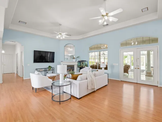 a living room with furniture and a chandelier