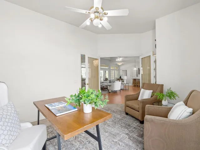 a view of a dining room with furniture and a chandelier