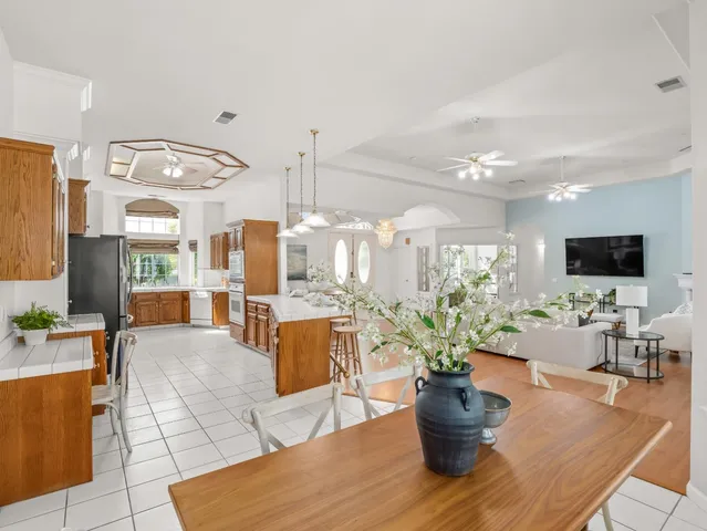 a large kitchen with a large counter top appliances and cabinets