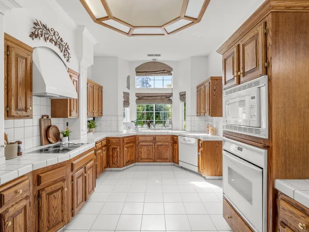 a spacious bathroom with a granite countertop shower a sink and a mirror