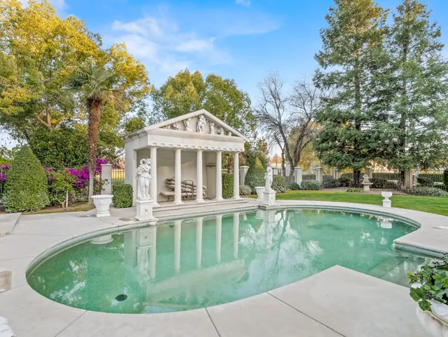 an aerial view of a house with outdoor seating