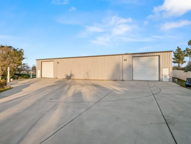 a view of yard with swimming pool and trees