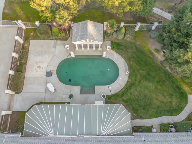 a view of a house with backyard and sitting area